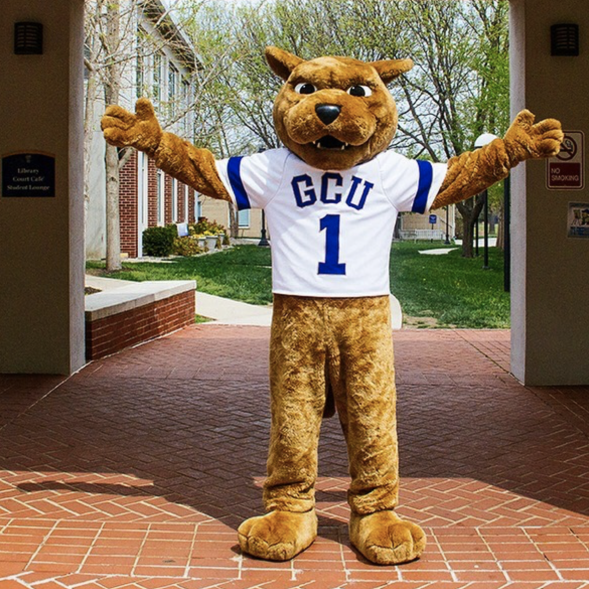 GCU mascot Roary the lion standing in an archway with his arms outstretched
