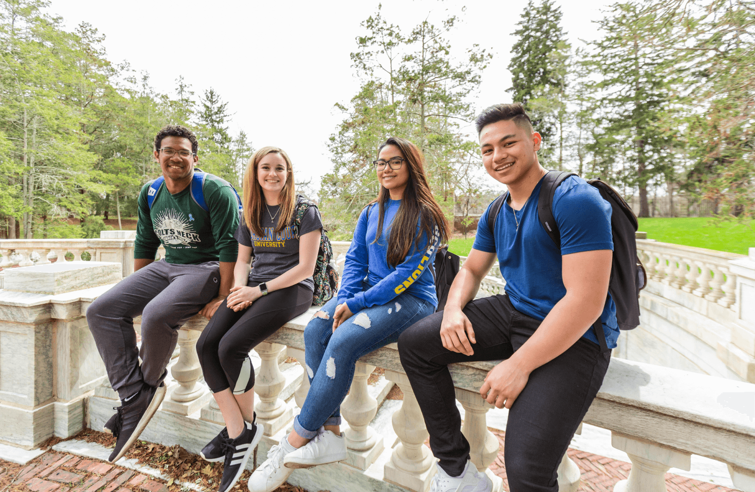 Group of students sitting outside smiling together